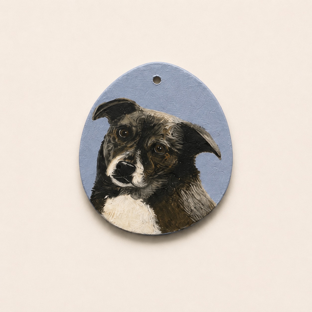 Acrylic portrait of a black and white collie mix on an egg-shaped clay pendant