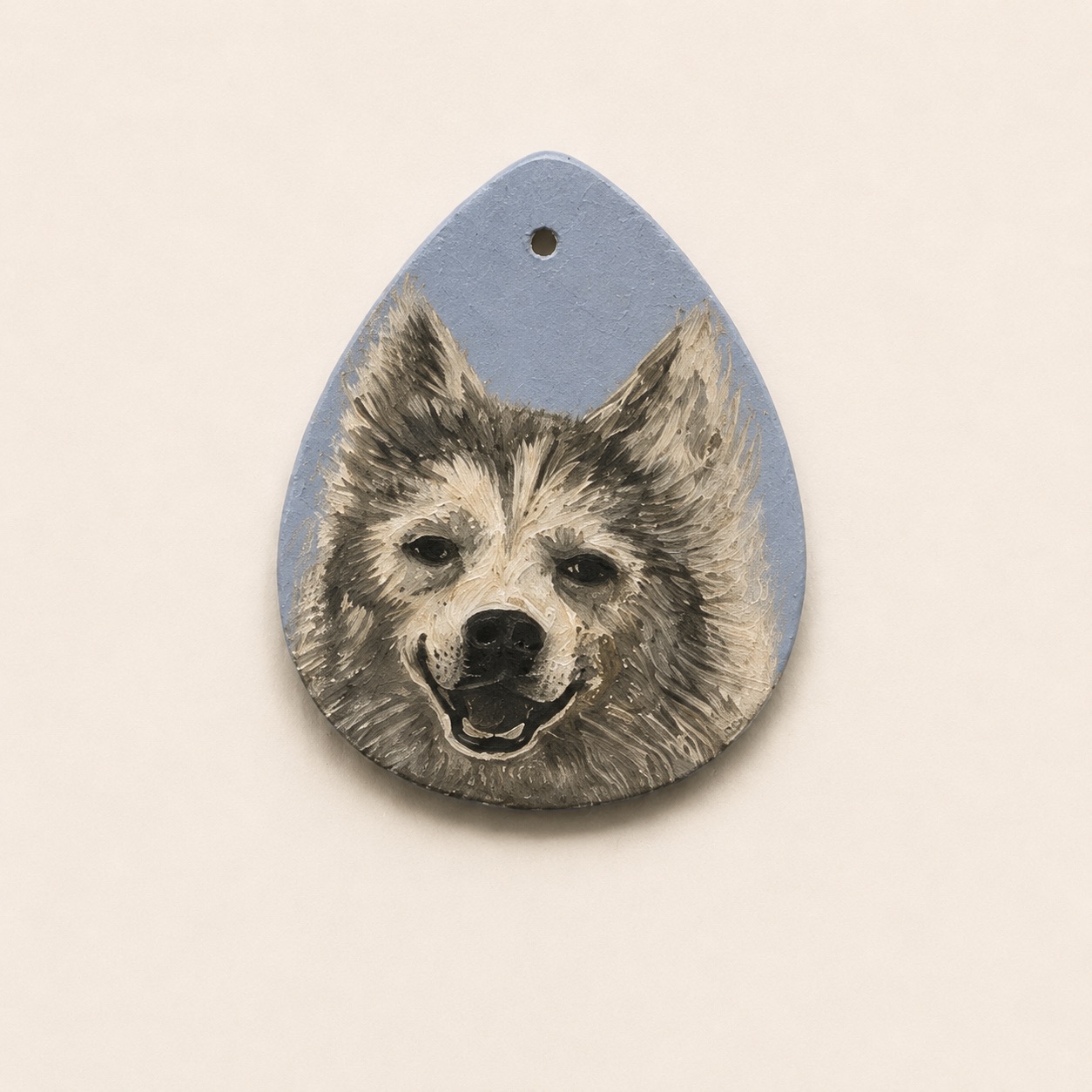 Acrylic portrait of a smiling grey husky mix on a teardrop clay pendant