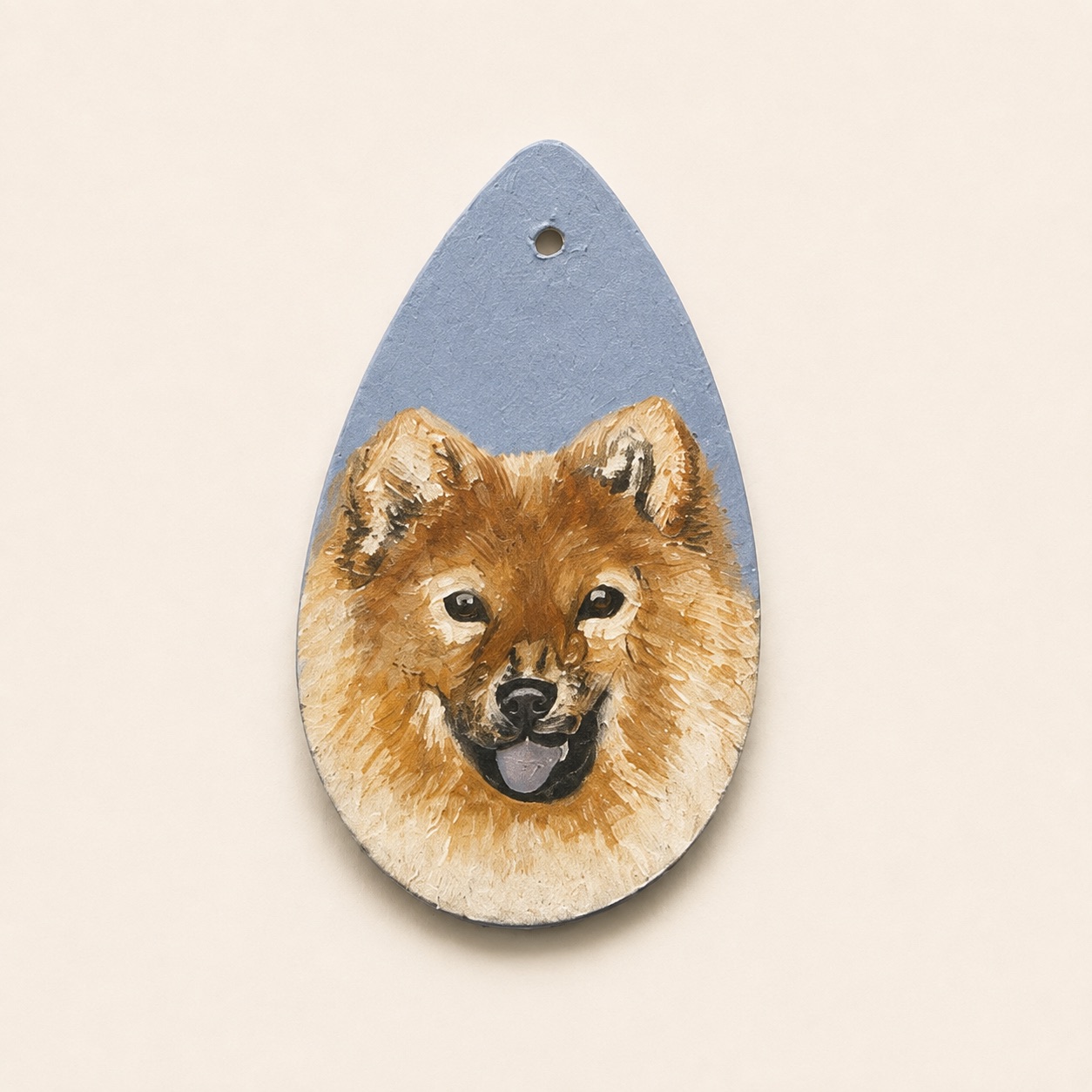 Acrylic portrait of a smiling red Finnish Spitz on a teardrop clay pendant